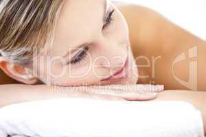 Close-up of a beautiful woman lying on a massage table