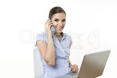 Happy business female with laptop and wireless phone