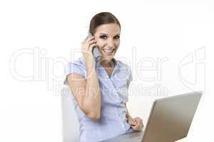 Happy business female with laptop and wireless phone