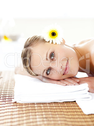 Portrait of a attractive woman lying on an massage table smiling