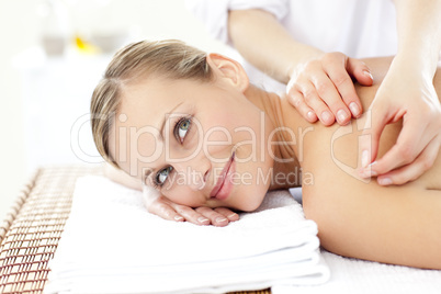 Smiling blond woman receiving an acupuncture treatment