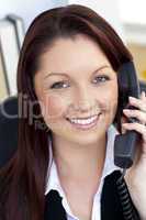 Confident businesswoman talking on phone smiling at the camera
