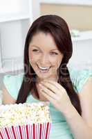 Bright caucasian woman holding popcorn