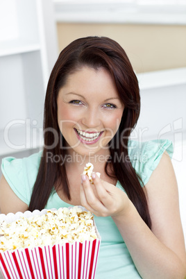 Bright caucasian woman holding popcorn