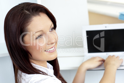 Charming businesswoman using her laptop