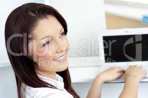 Charming businesswoman using her laptop