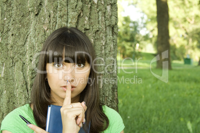 Female in a park with a notebook