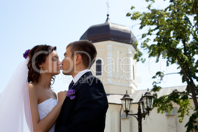 Bride and groom posing and kissing