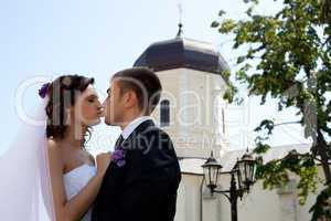 Bride and groom posing and kissing