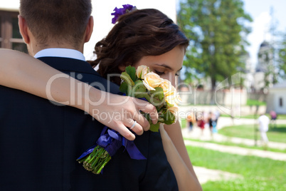 Bride and groom dancing outside with flowers