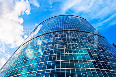 Blue skyscraper and cloudy sky