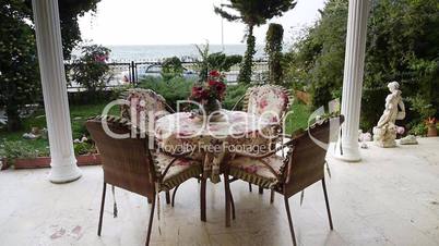 Table on porch overlooking garden and sea