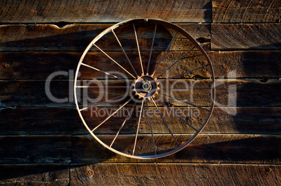 Wagon wheel on barn wall