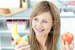 Positive caucasian woman holing a bananan and an apple