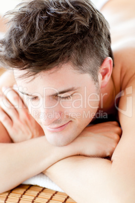Portrait of a smiling man lying on a massage table