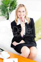 Self-assured businesswoman smiling at the camera sitting on the