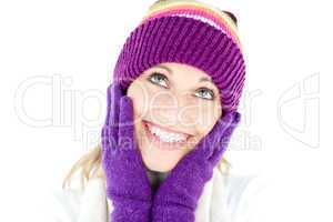 Cheerful young woman with cap and gloves in the winter