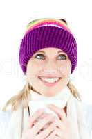 Merry young woman holding a cup wearing a cap in the winter
