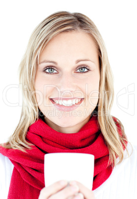 Portrait of a smiling woman holding a cup in the winter
