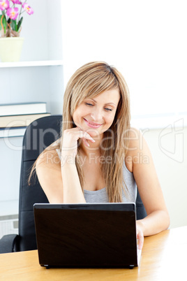 Charismatic young businesswoman using her laptop