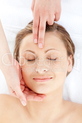 Positive young woman having a head massage