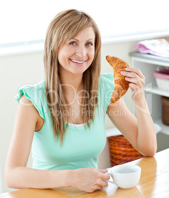 Animated young woman eating a croissant holding a cup in the kit
