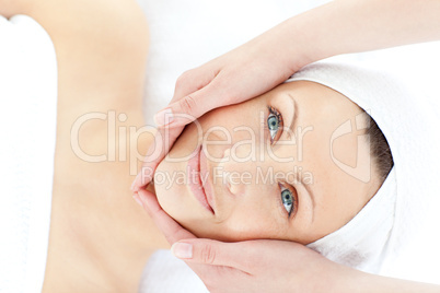 Young positive woman enjoying a facial massage