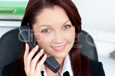 Confident young businesswoman talking on phone