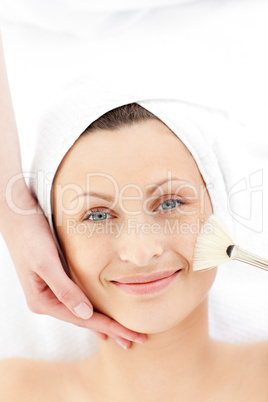 Smiling young woman receiving a beauty treatment