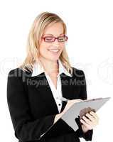 Concentrated businesswoman writing on a clipboard