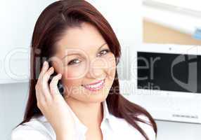 Attractive caucasian businesswoman talking on phone smiling at t