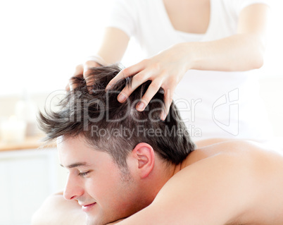 Happy young man receiving a head massage