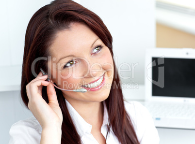 young businesswoman wearing headphones in her office