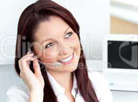 young businesswoman wearing headphones in her office