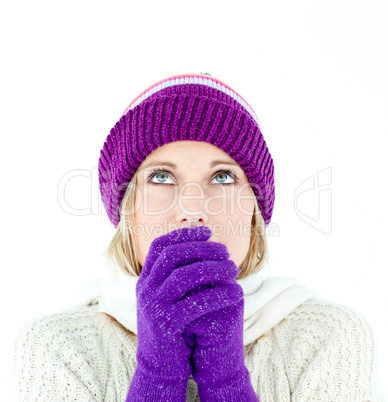 Freezing young woman wearing gloves looking upwards