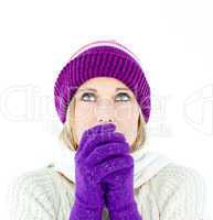 Freezing young woman wearing gloves looking upwards