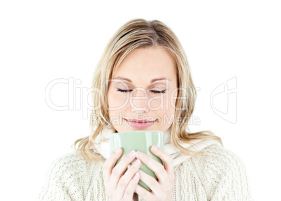 Happy woman enjoying a hot coffee standing