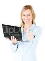 Jolly young businesswoman holding a laptop with thumb up