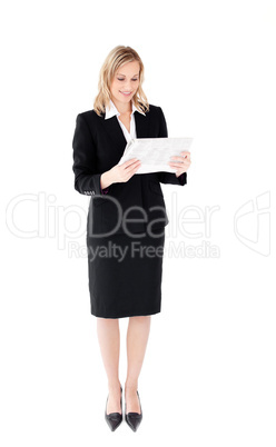 Self-assured businesswoman reading a newspaper