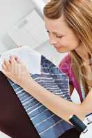 Pretty woman sewing  in the kitchen