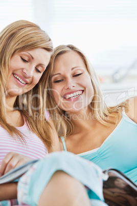 Laughingl friends reading a book