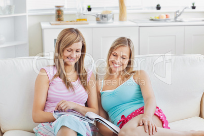 Charming friends reading a book
