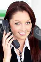 Charming young businesswoman talking on phone smiling at the cam