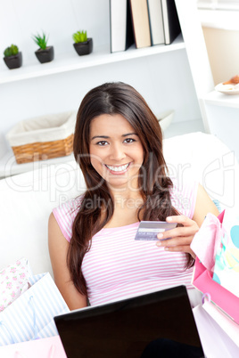 Animated asian woman holding a card smiling at the camera