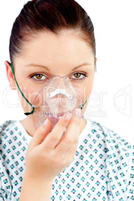 Diseased young woman with an oxygen mask looking at the camera