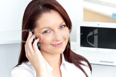Elegant businesswoman talking on phone smiling at the camera
