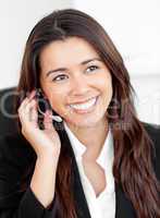 Portrait of an attractive asian businesswoman talking on phone w