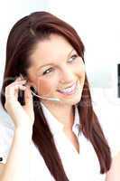 Smiling businesswoman talking on phone using headphones