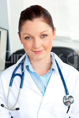 Self-assured female doctor smiling at the camera sitting