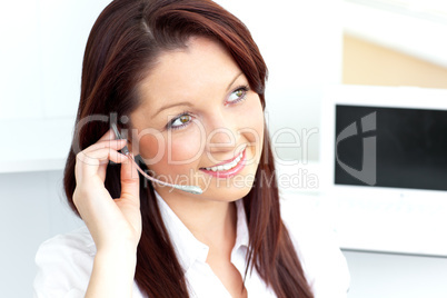 Pretty businesswoman talking on phone using headphones